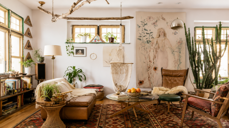 Beautifully balanced living room with neutral furniture, natural wood, greenery, artwork, and warm natural light